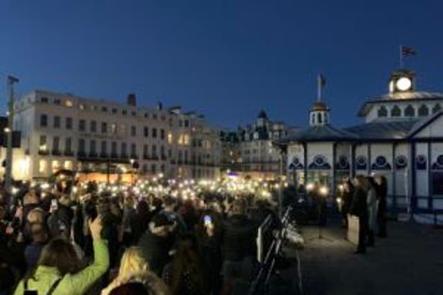 <p>People at a vigil for Sabina Nessa at Eastbourne Pier in East Sussex</p>