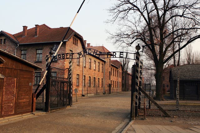 <p>A view showing the entrance gates to Auschwitz with the words ‘Arbeit Macht Frei'</p>
