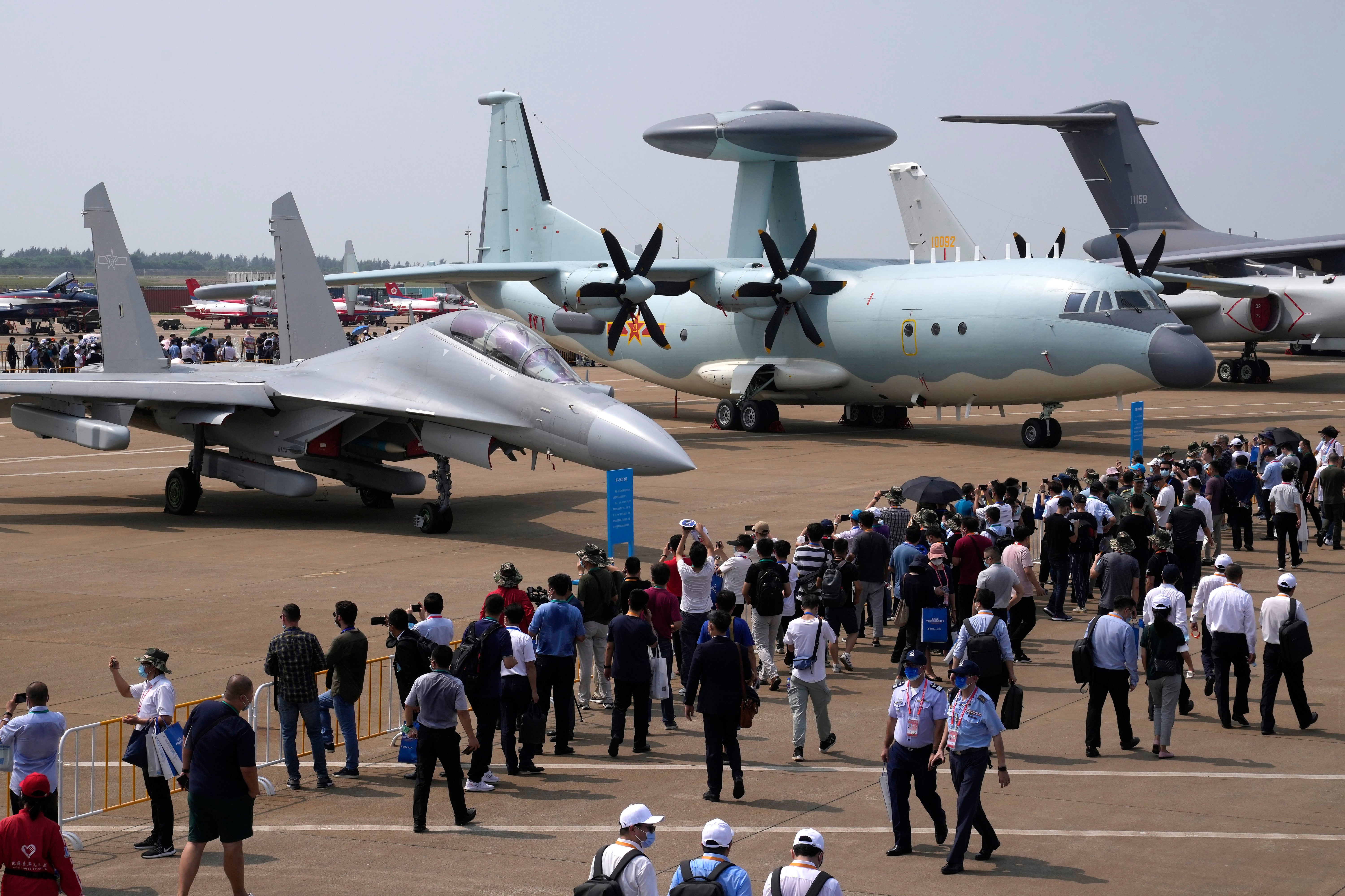 File photo. Visitors view the Chinese military's J-16D electronic warfare airplane, left, and the KJ-500 airborne early warning and control aircraft at right during 13th China International Aviation and Aerospace Exhibition on 29 September in Zhuhai in southern China's Guangdong province