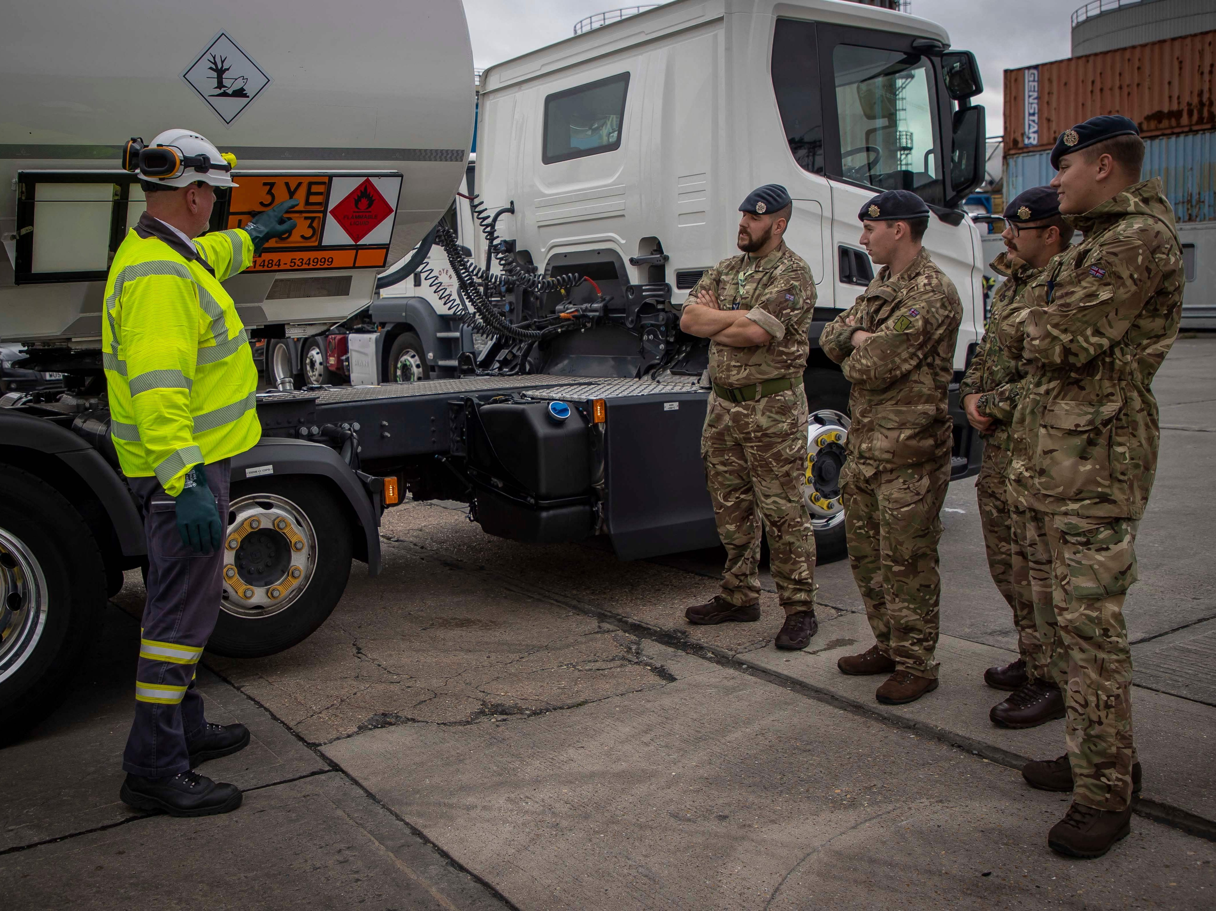 A driver training instructor for Hoyer Petrolog UK shows Army and RAF driver important features of fuel tankers