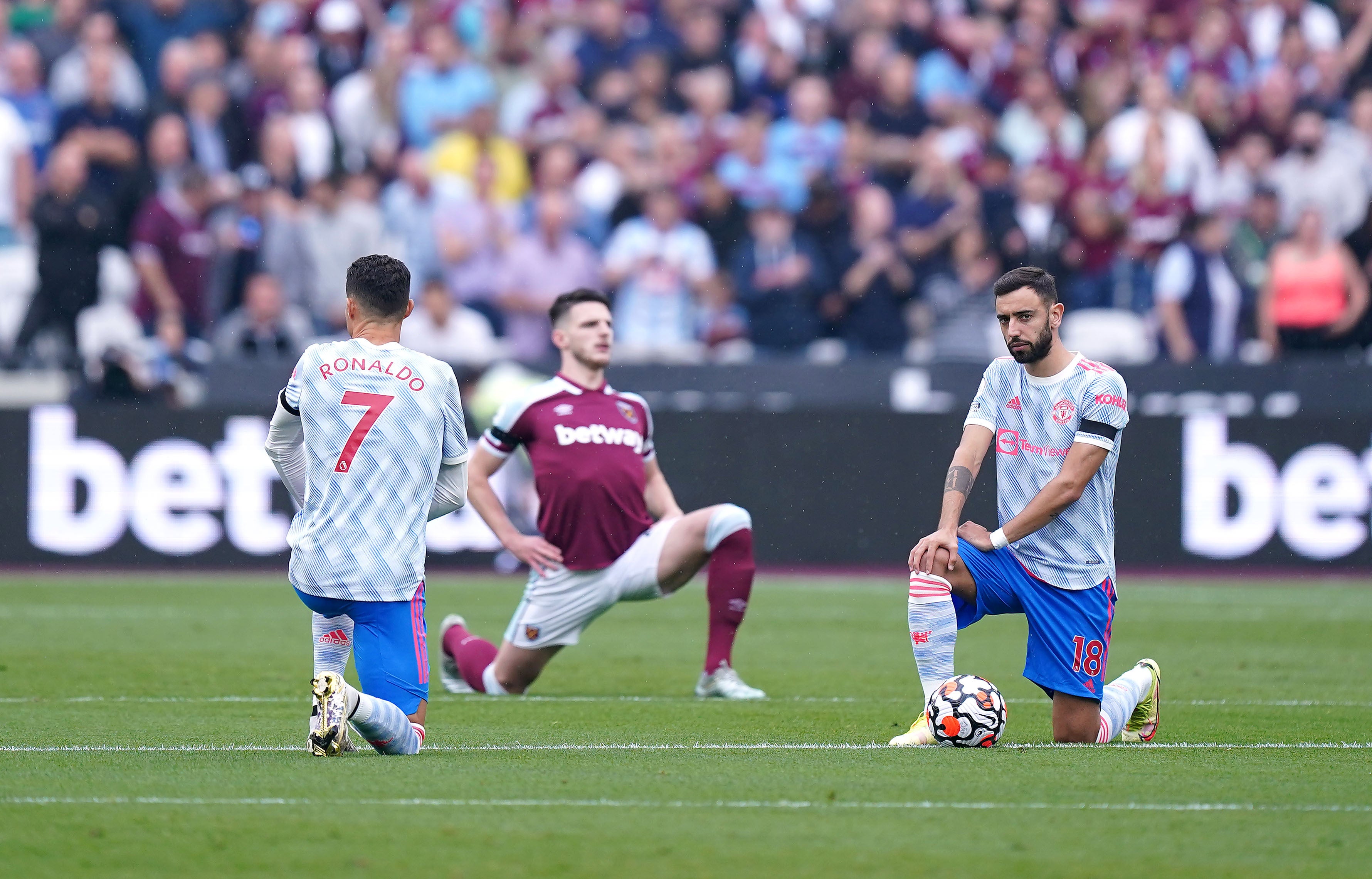 Manchester United’s Cristiano Ronaldo (left), Bruno Fernandes (right) and West Ham’s Declan Rice take a knee prior ahead of their Premier League match in September (Mike Egerton/PA).