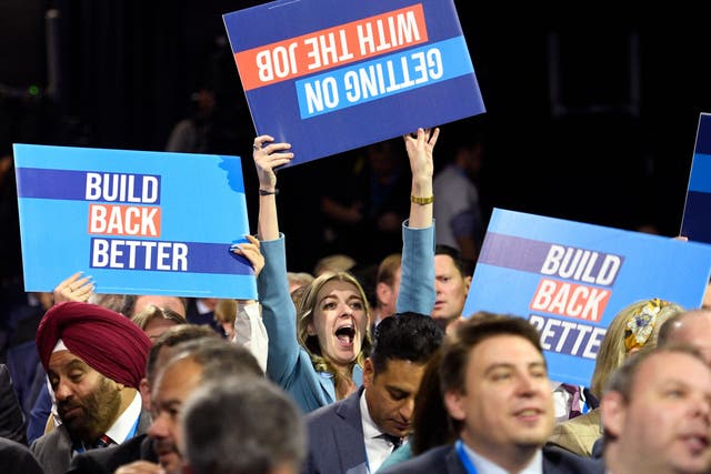 <p>People raise placards as they wait for the keynote speech of Britain's prime minister on the final day of the annual Conservative Party conference in Manchester. </p>
