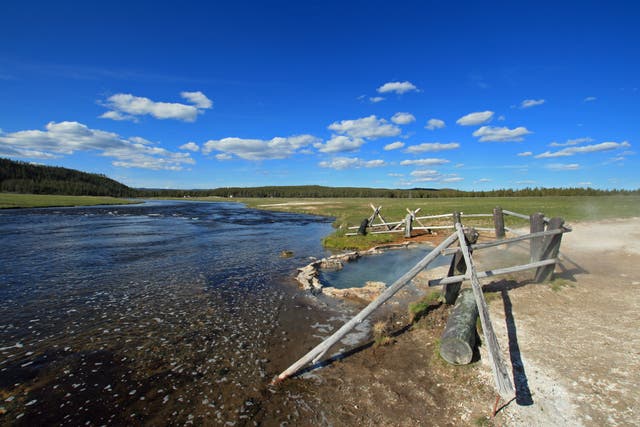 <p>Maidens Grave Hot Spring flowing into the Firehole River in Yellowstone National Park in Wyoming,United States</p>