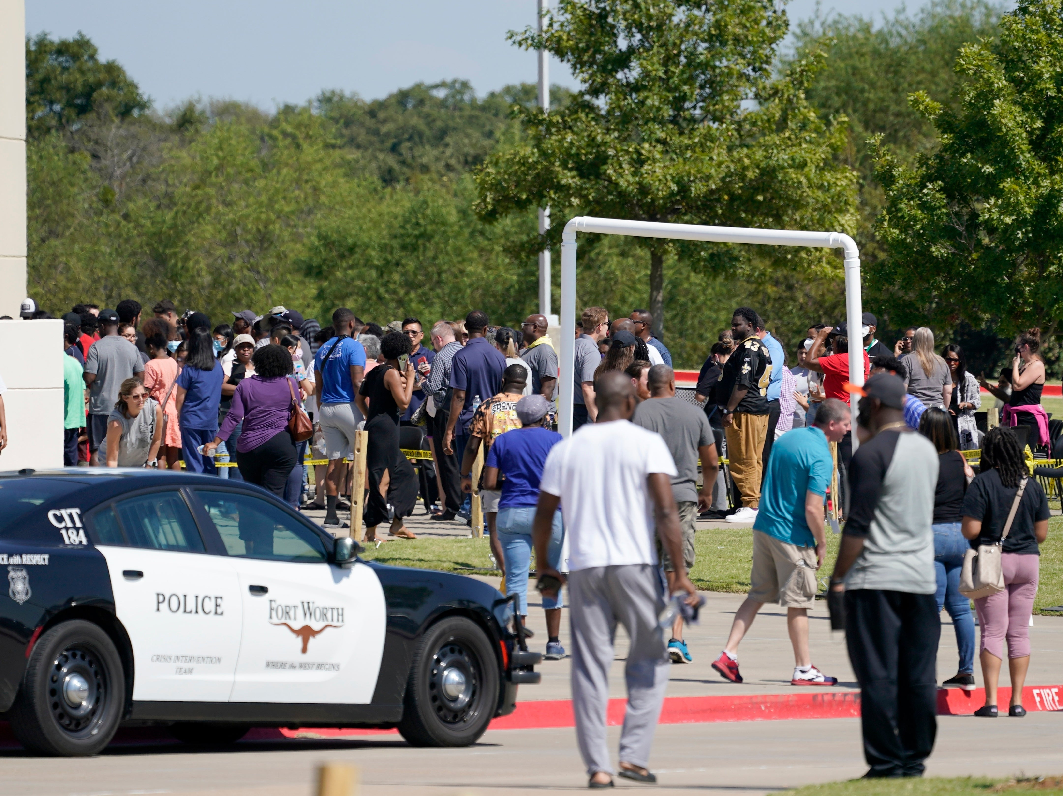 Families stand outside the Mansfield ISD Center for the Performing Arts waiting to be reunited with their children, Wednesday, Oct. 6, 2021