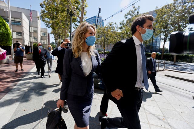 <p>Theranos founder Elizabeth Holmes and her partner Billy Evans leaves the Robert F. Peckham U.S. Courthouse after the delivery of opening arguments in her trial, in San Jose, California, U.S., September 8, 2021. </p>