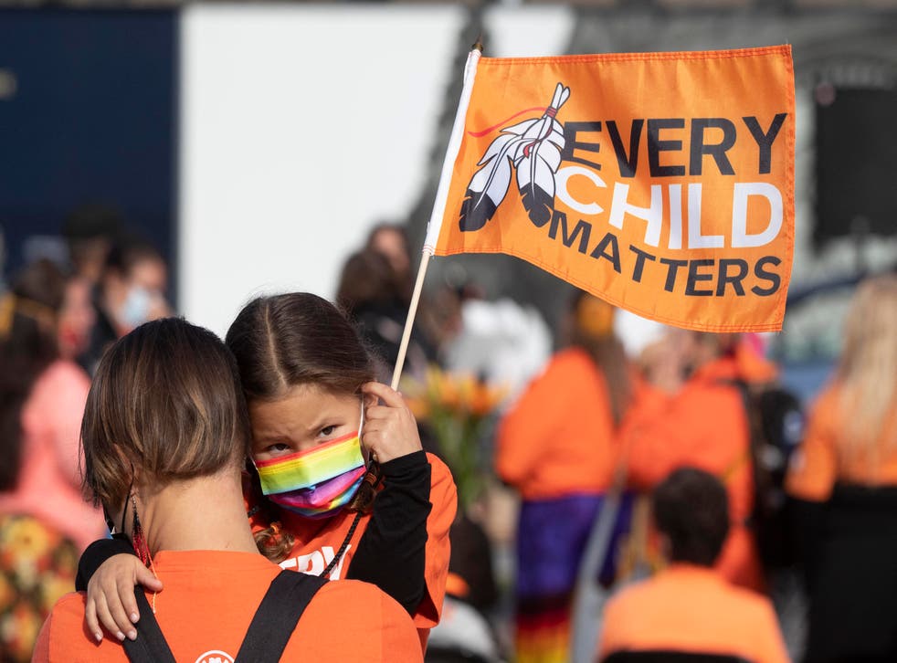 <p>An indigenous child holds a flag during the first National Day for Truth and Reconciliation, on Parliament Hill in Ottawa in September</p>