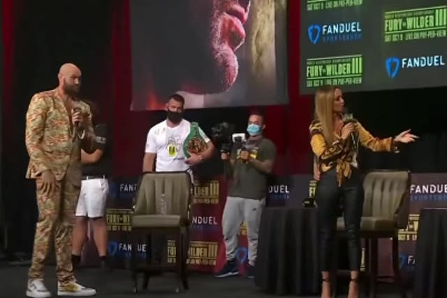 <p>Kate Abdo attempts to make Tyson Fury and Deontay Wilder engage in a face-off</p>