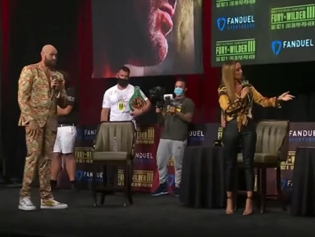 <p>Kate Abdo attempts to make Tyson Fury and Deontay Wilder engage in a face-off</p>