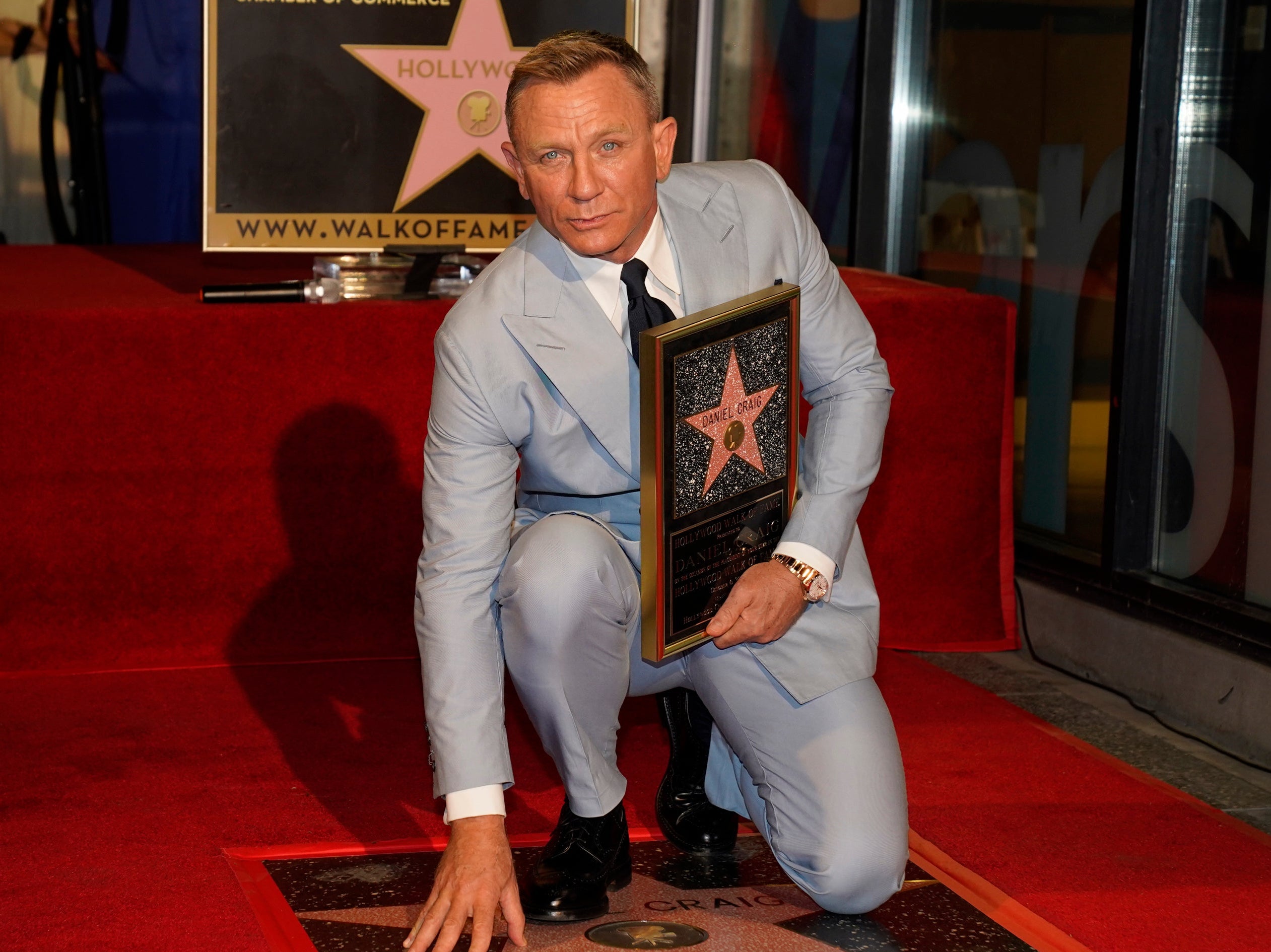 Daniel Craig poses atop his new star on the Hollywood Walk of Fame