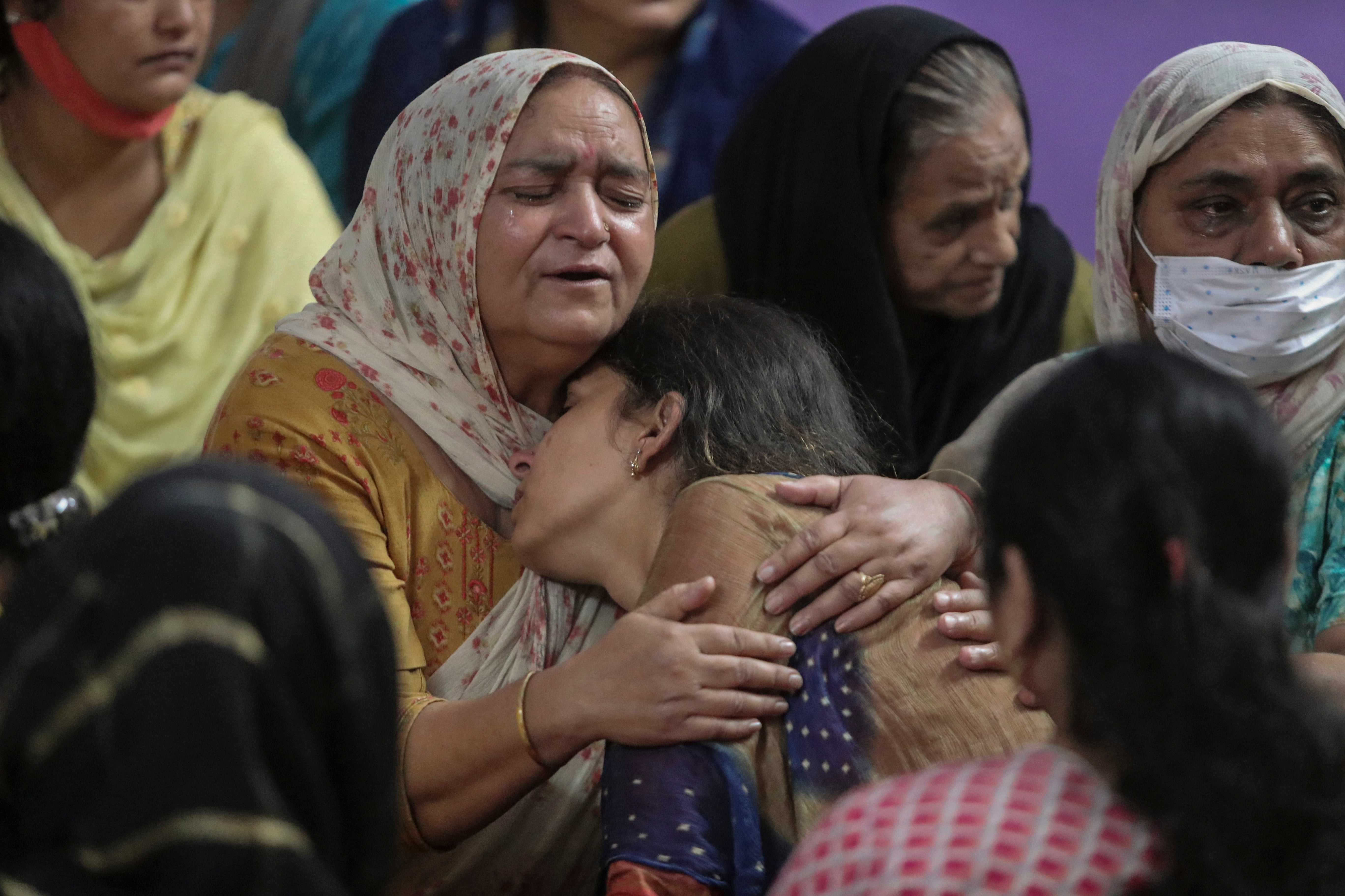 Relatives of Deepak Chand, one of two schoolteachers shot dead by assailants in India’s Kashmir on Thursday mourn at their residence