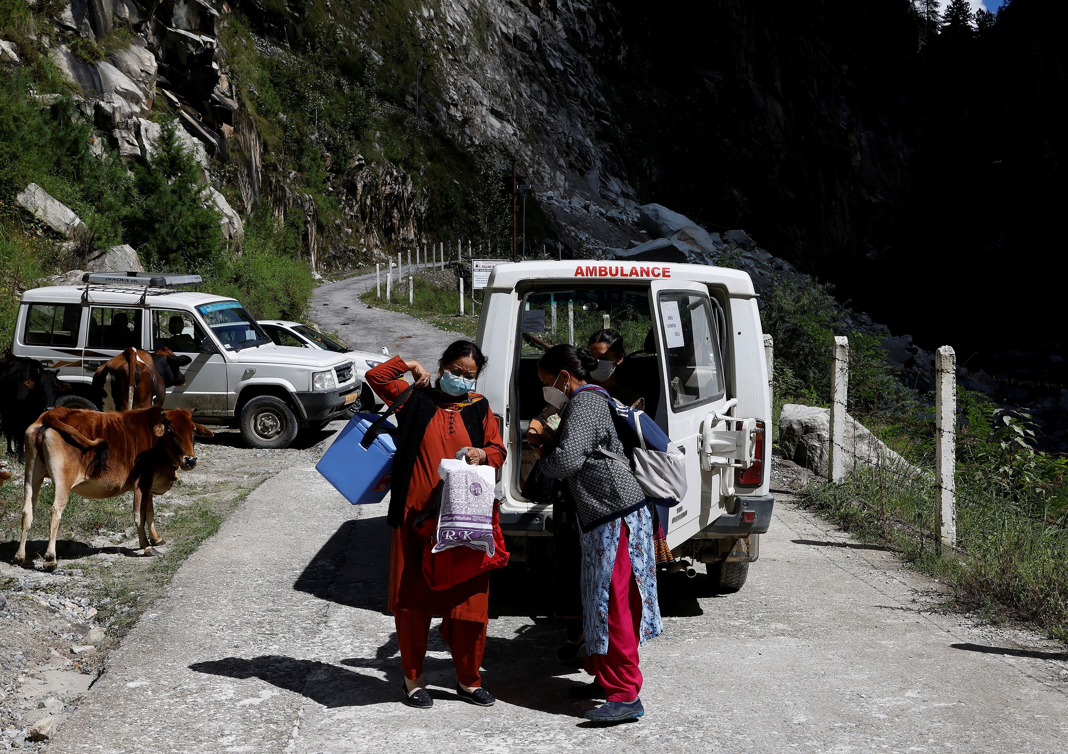 Health workers organise the vaccines before their trek through the mountains