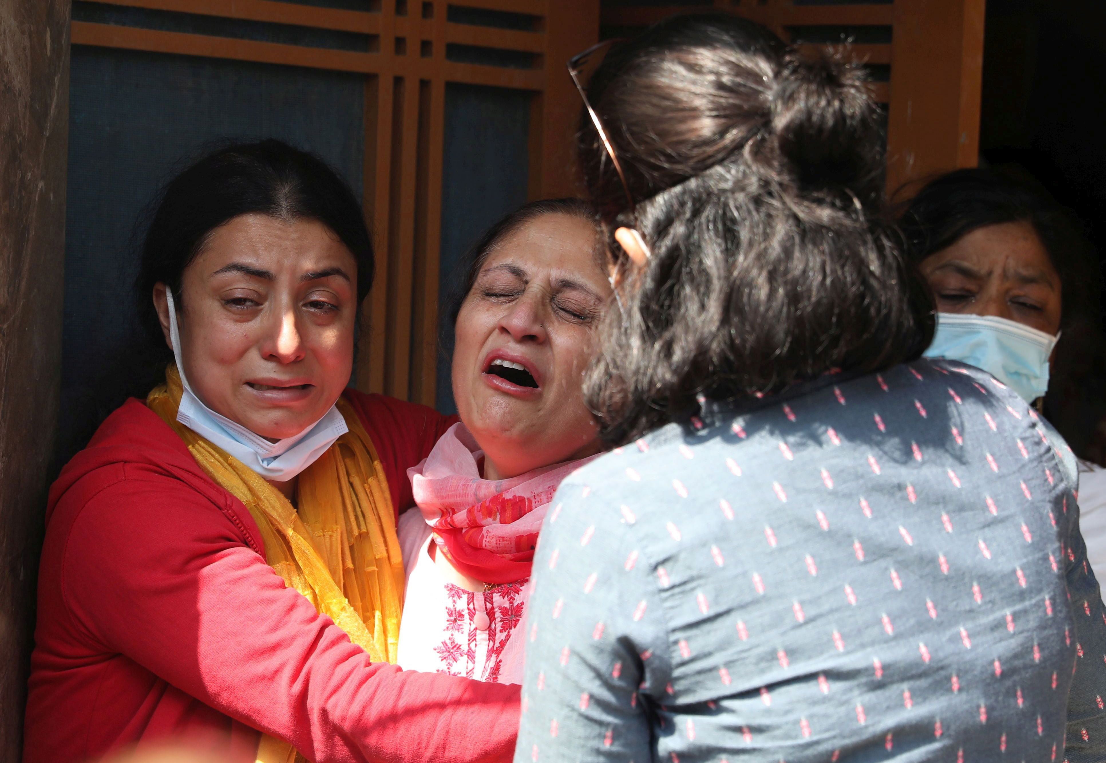 Family mourn the of Makhan Lal Bindroo, during his cremation in Srinagar