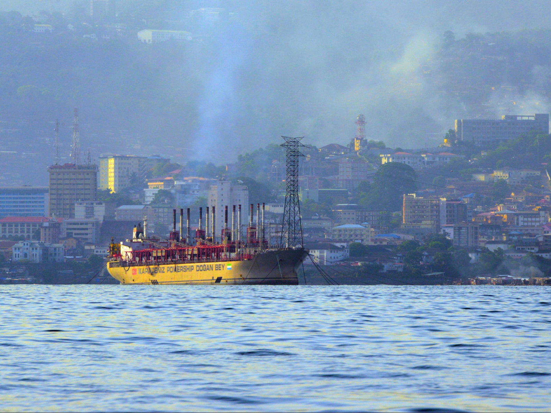 Smoke rises over a port in Freetown, the capital of Sierra Leone in West Africa