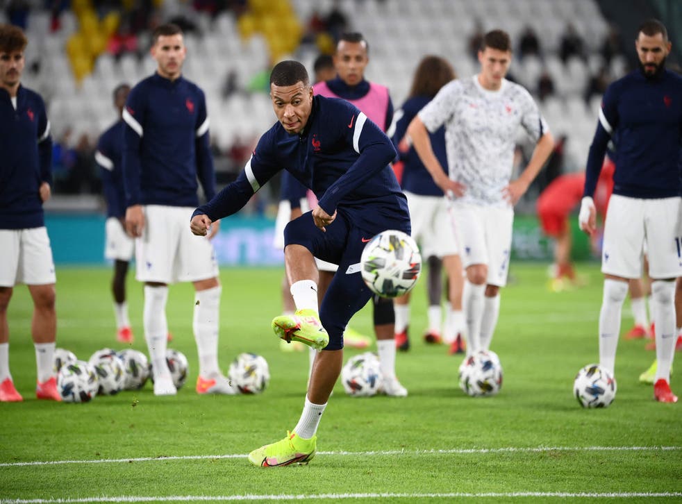 <p>Kylian Mbappe warms up before kick-off</p>