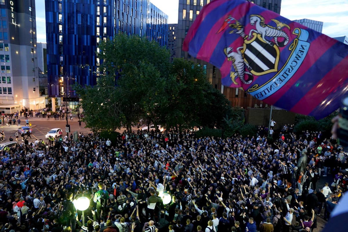 Newcastle United fans celebrate wildly outside St James’s Park after Saudi-led takeover confirmed