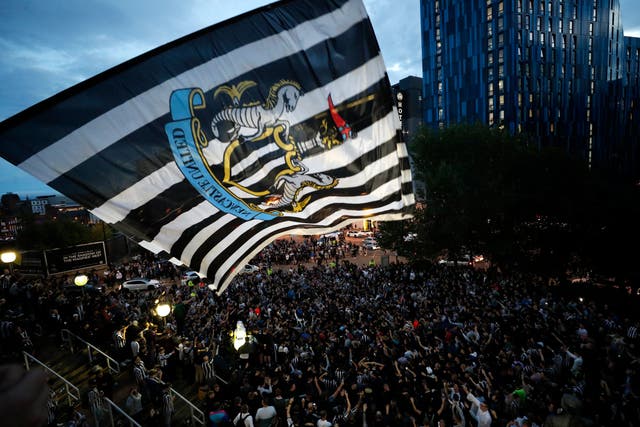 <p>Newcastle fans celebrate the takeover at St James’ Park</p>