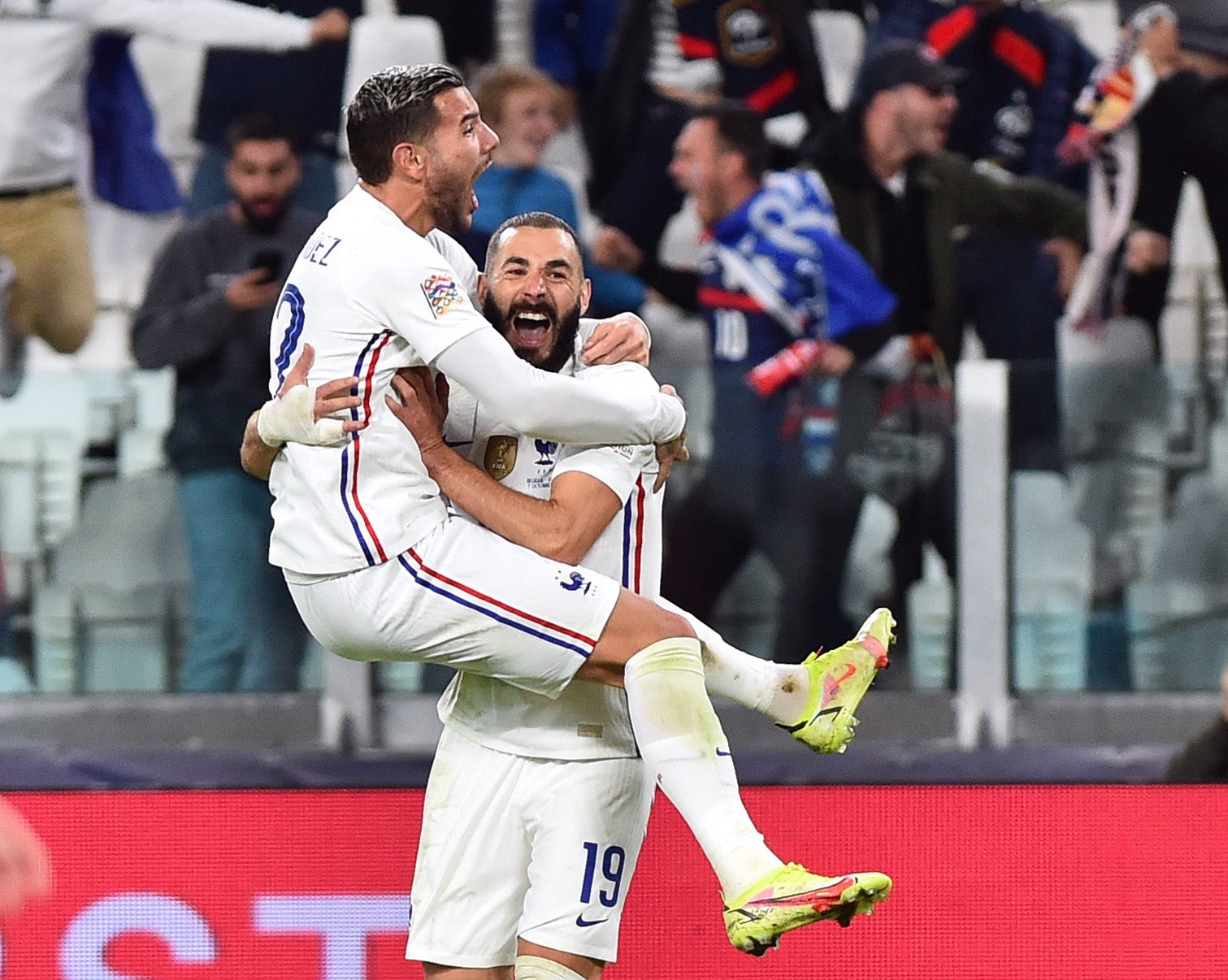 Theo Hernandez celebrates with Karim Benzema