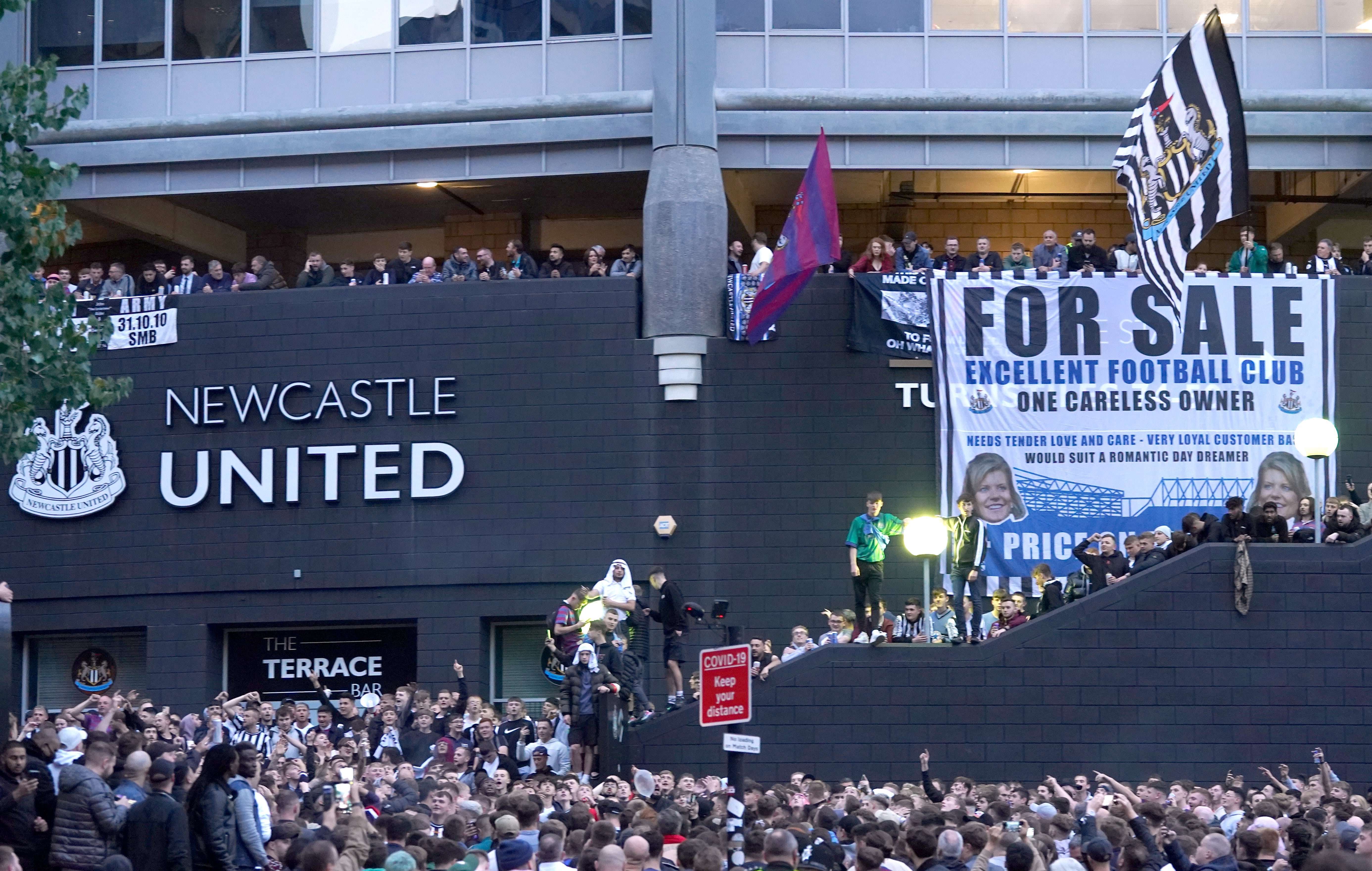 Newcastle fans celebrate the completion of the takeover (Owen Humphreys/PA).
