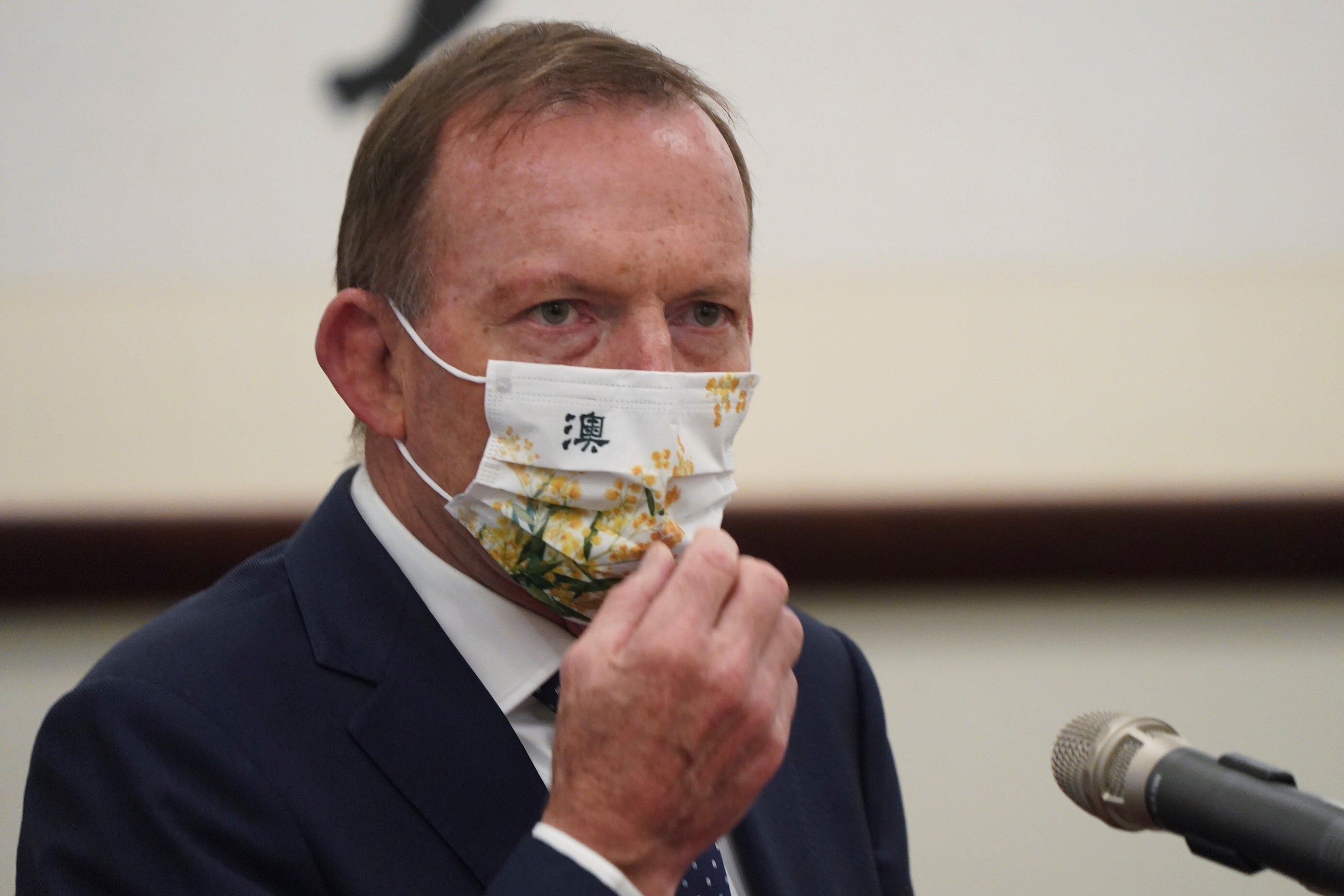 File: Former Australian prime minister Tony Abbott wears a mask with the Chinese character for ‘Australia’ during a meeting with Taiwanese President Tsai Ing-wen