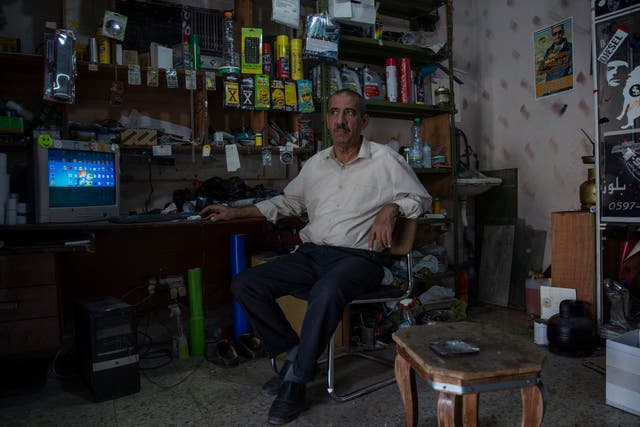 <p>Palestinian Mustafa Erekat, whose son Ahmed was shot dead by Israeli forces at a West Bank checkpoint last year and held his body after, sits at his shop in the village of Abu Dis, South of Ramallah</p>