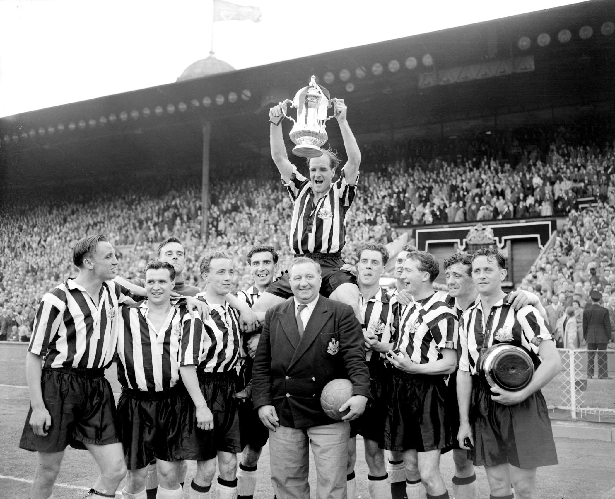 Newcastle captain Jimmy Scoular lifts the FA Cup aloft after a 3-1 victory over Manchester City in the 1955 final (PA)
