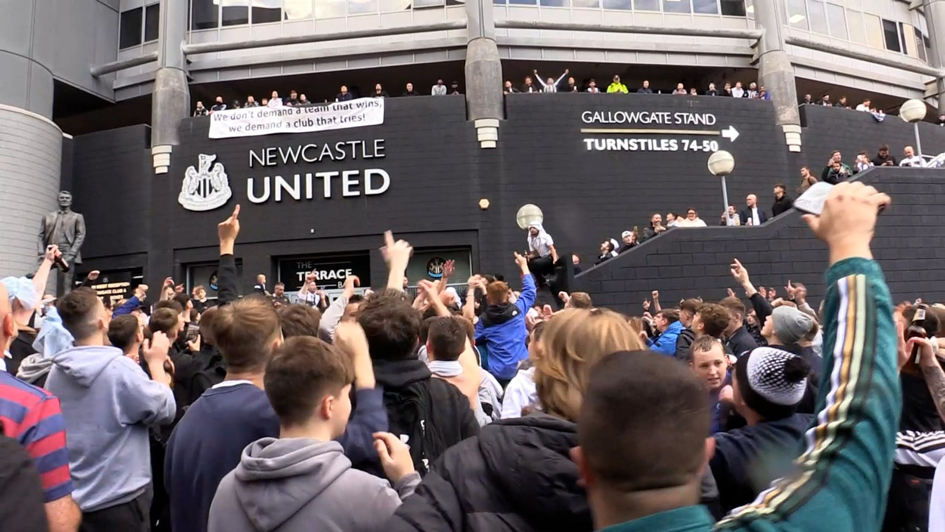 Jubilant Newcastle fans celebrate the club’s Saudi takeover outside the stadium
