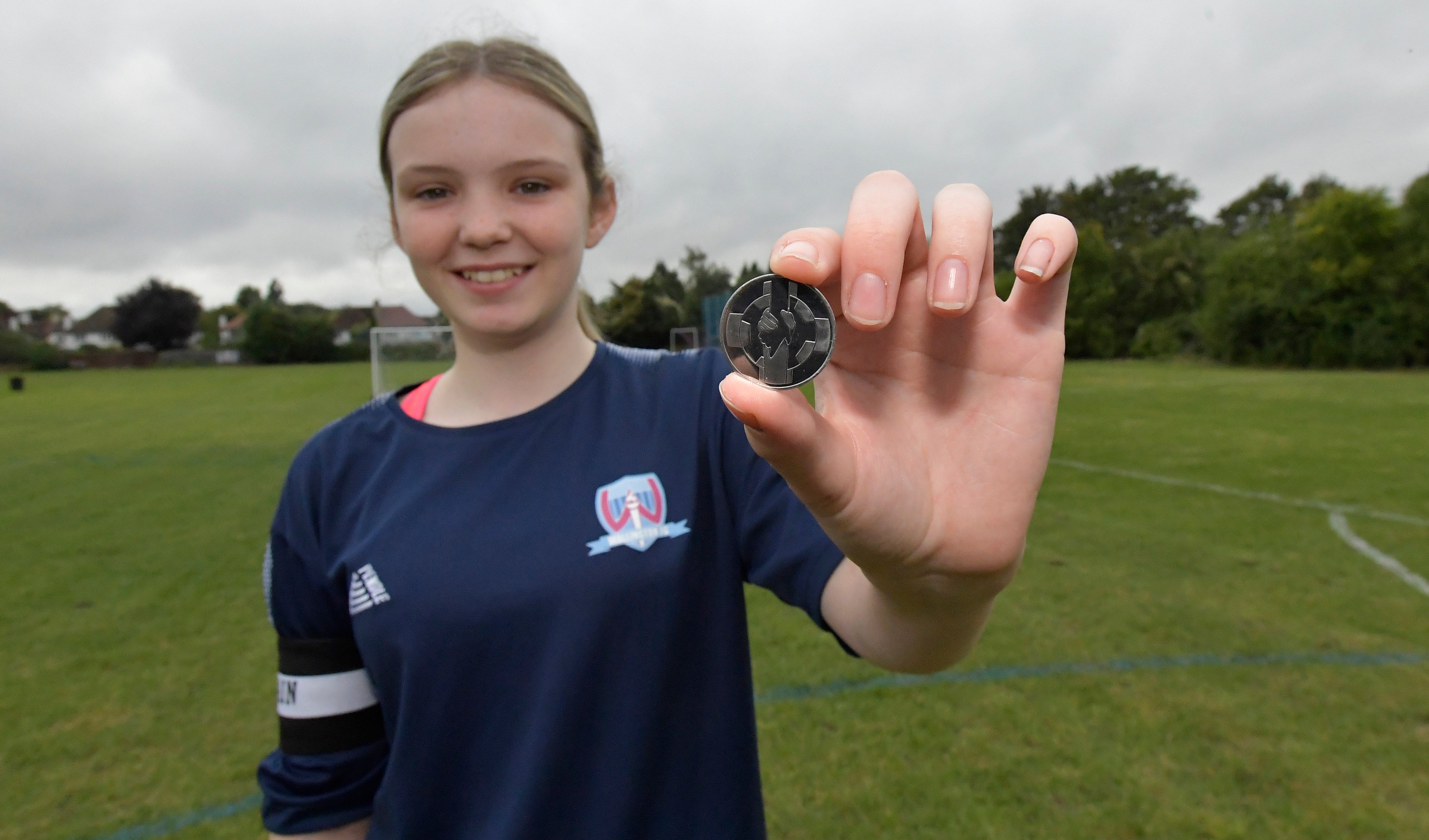 Competition winner Chloe displays her winning Coin for Respect design (Handout/Nationwide/PA)
