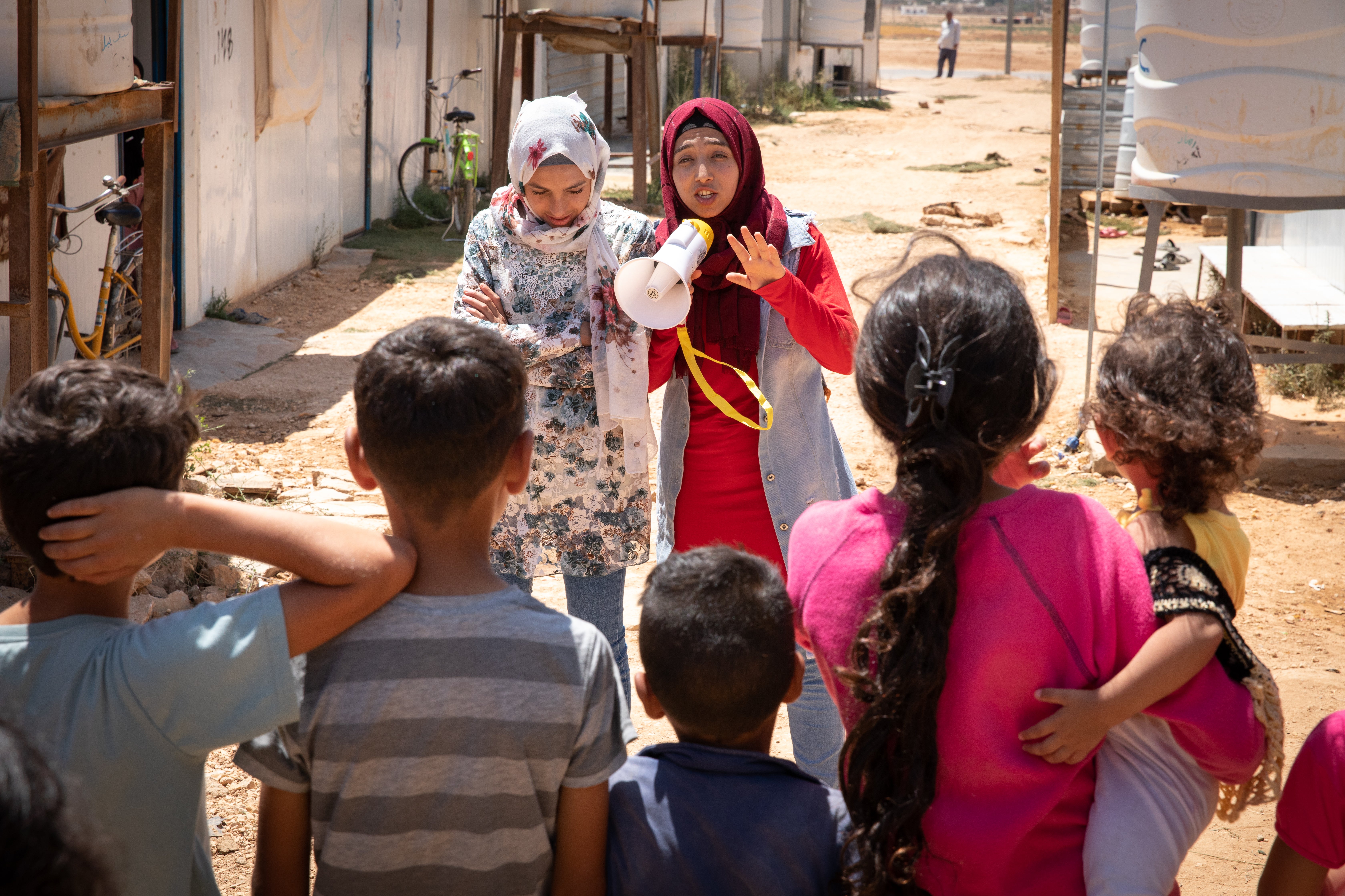 Hiba, 17, and Rama, 14, perform to a group of children in Za’atari camp for Syrian refugees, Jordan