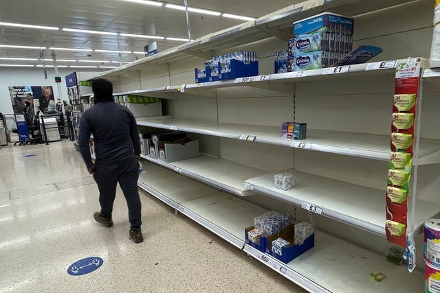 <p>No goods: A supermarket in London is left with shelves empty of some items </p>