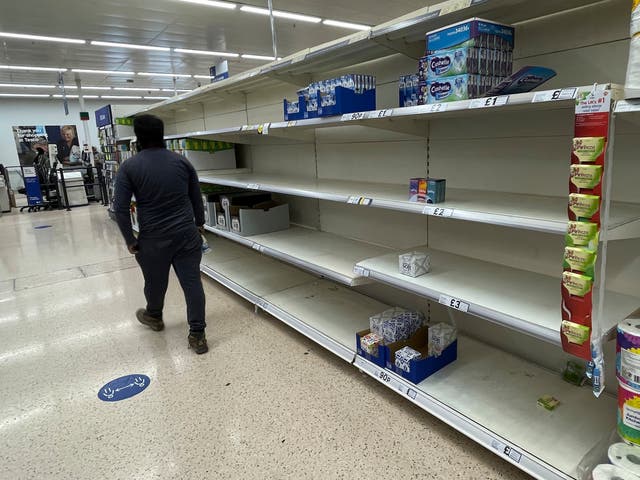 <p>No goods: A supermarket in London is left with shelves empty of some items </p>