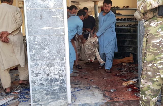 <p>A body is recovered in the aftermath of the Gozar-e-Sayed Abad mosque attack</p>