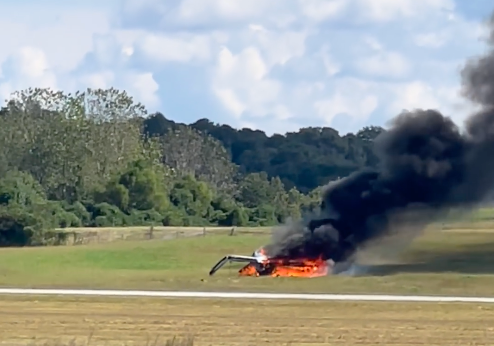 The wreckage of a small aircraft smolders at DeKalb Peachtree Airport, Georgia
