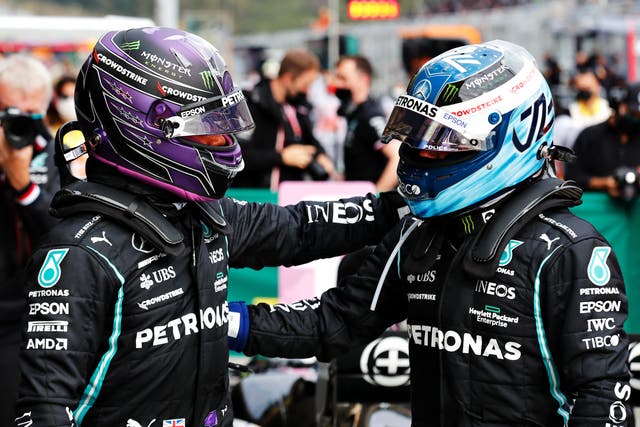 <p>Lewis Hamilton and Valtteri Bottas congratulate each other</p>