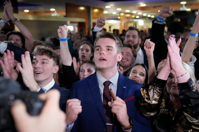 <p>Supporters of leader of centre-right Spolu (Together) coalition Petr Fiala react to election results in Prague</p>