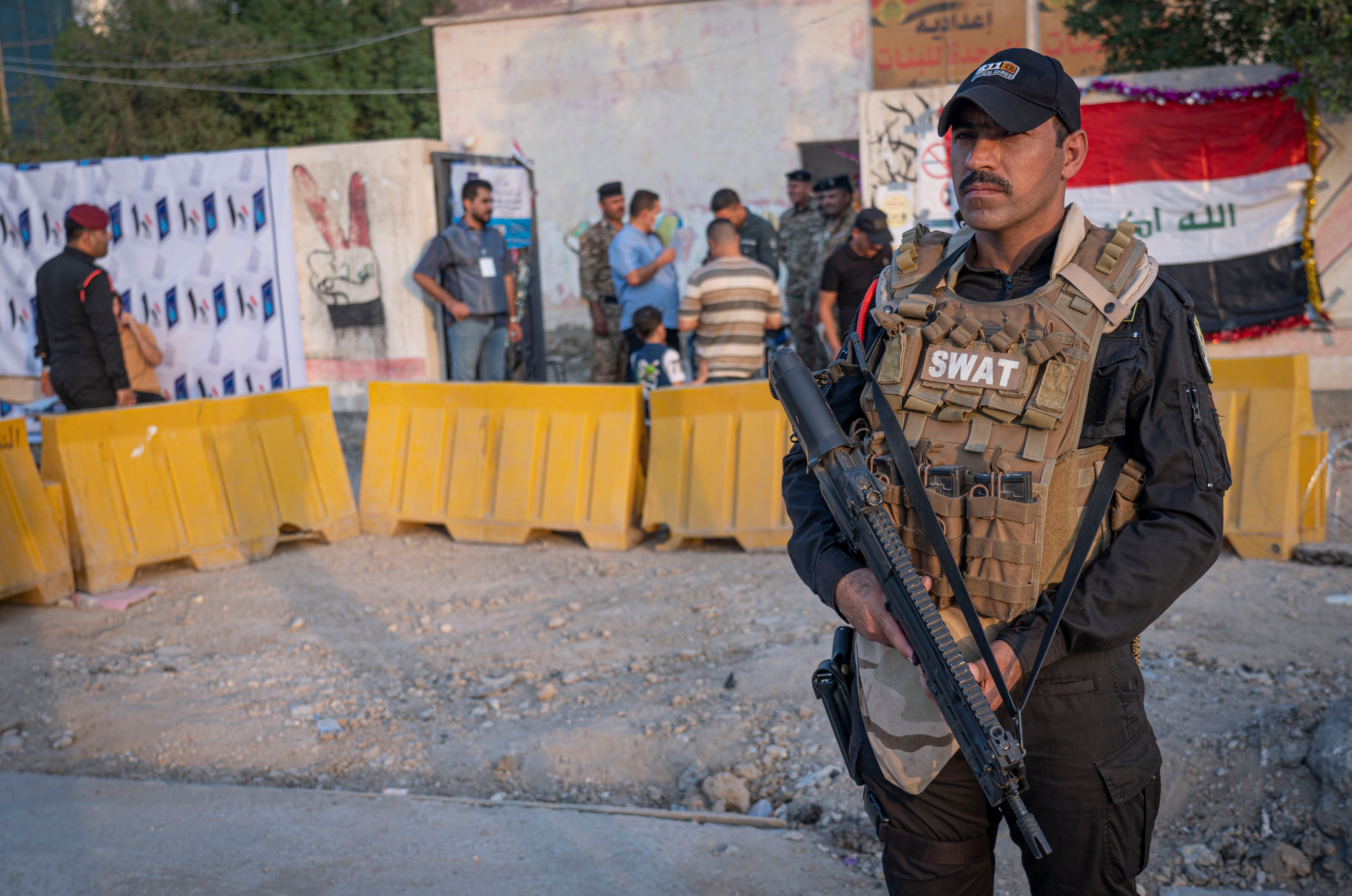 An Iraqi soldier guards a polling station in Nassiriya