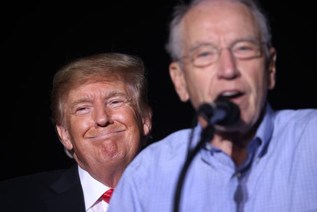 <p>Donald Trump stands behind Iowa senator Chuck Grassley at a rally in Iowa this October </p>
