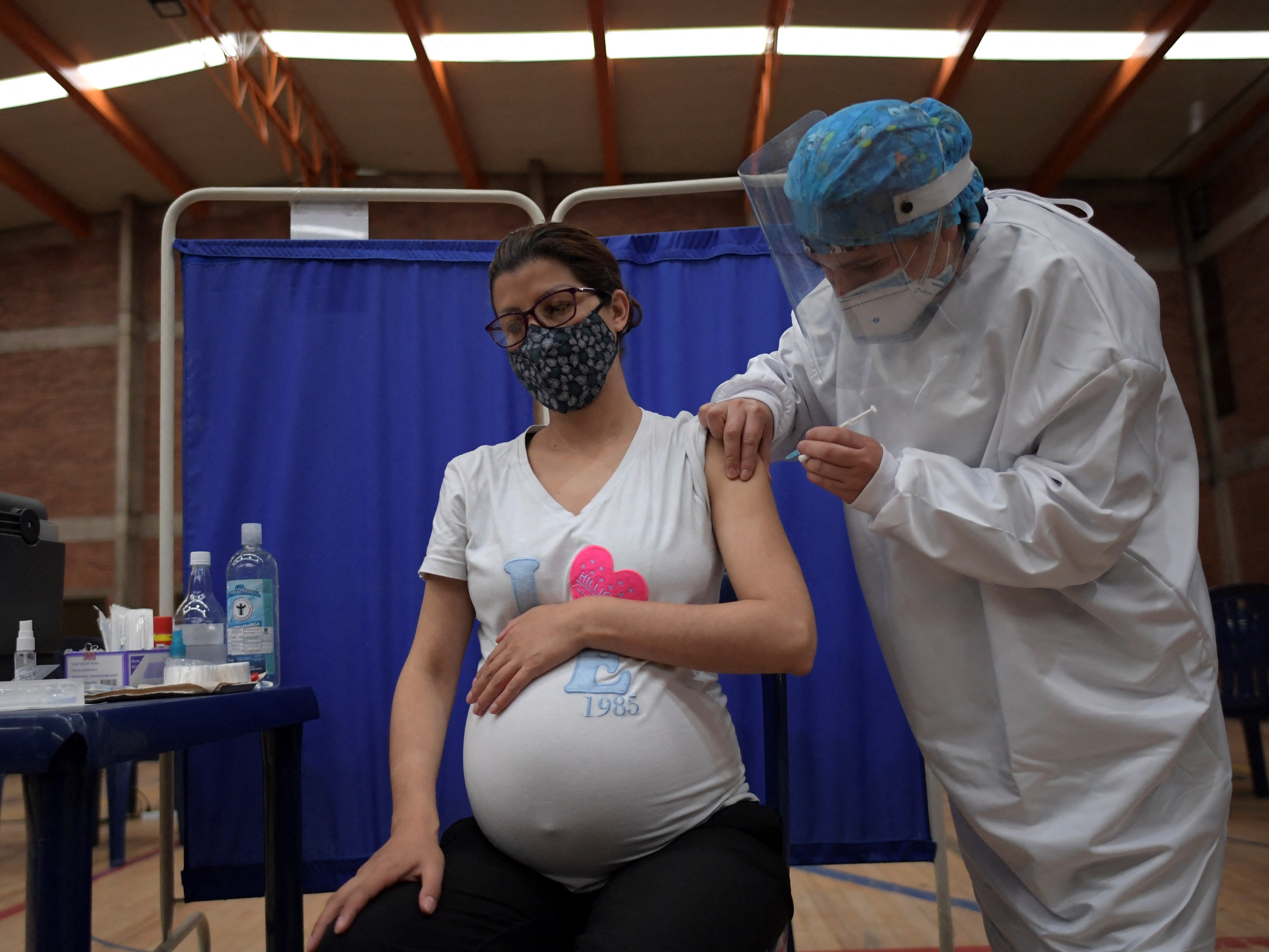 A pregnant woman receives a dose of the Pfizer-BioNTech vaccine