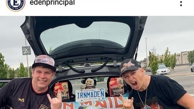 <p>Sharon Burns (right), principal of Eden High School, seen with Iron Maiden paraphernalia </p>