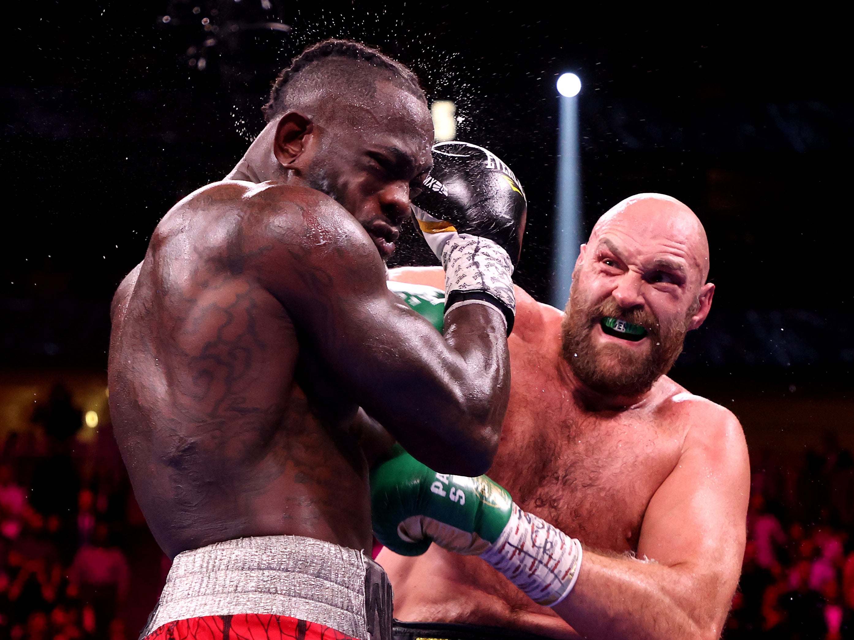 Tyson Fury punches Deontay Wilder during their WBC heavyweight title fight at T-Mobile Arena