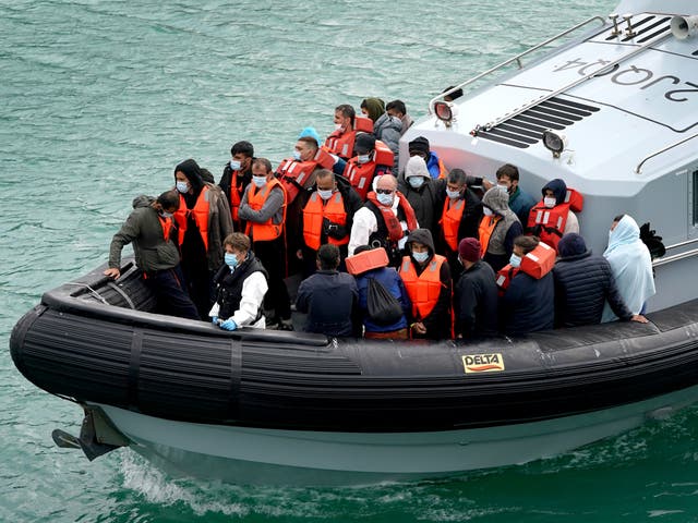 <p>This file photo from September shows a group of people thought to be migrants brought into Dover by Border Force officers</p>