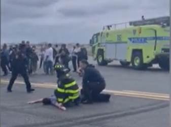 <p>The American Eagle passenger is pinned down by airport staff</p>