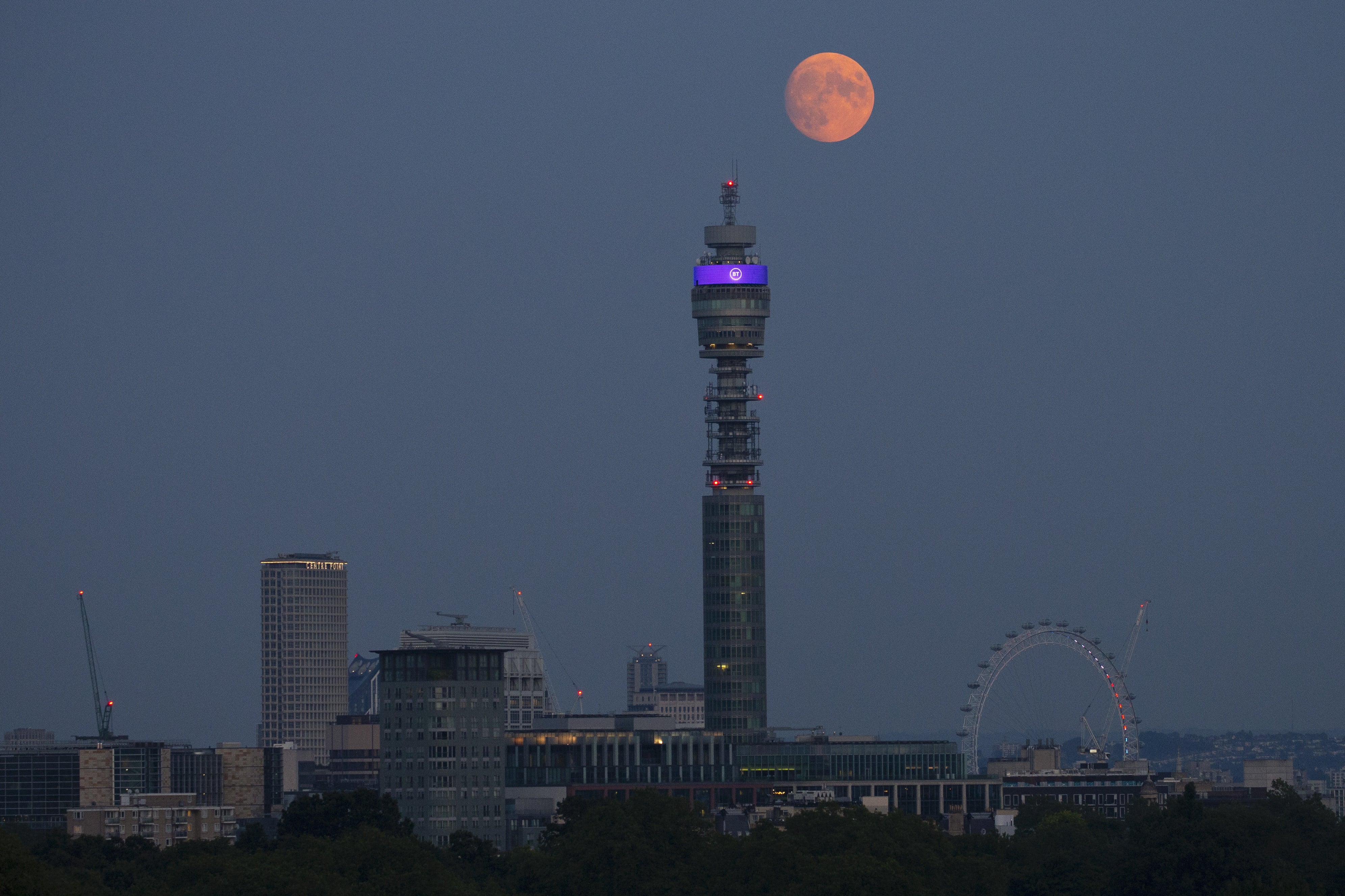 The moon rises over the BT Tower in central London (Hollie Adams/PA)