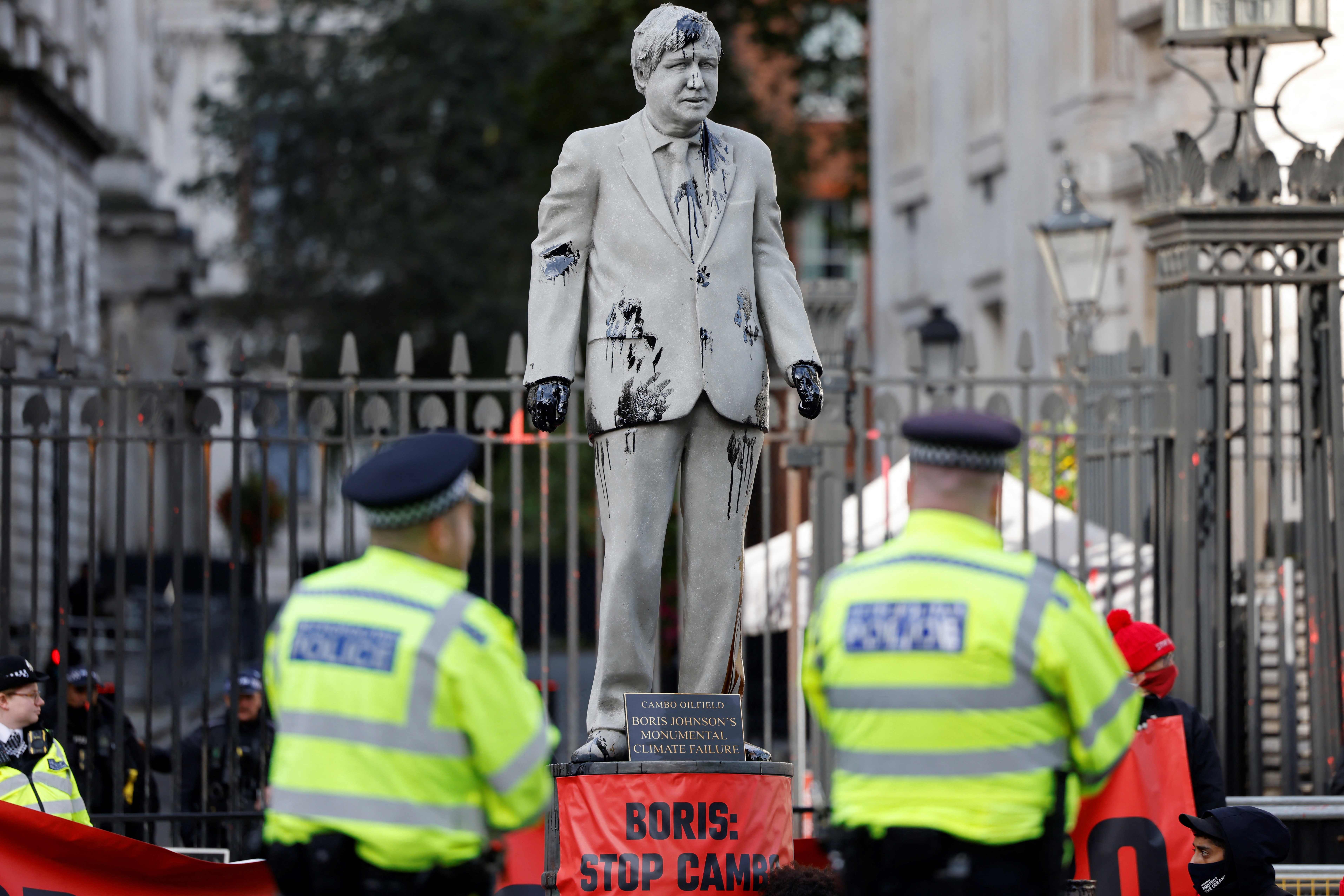 Climate protesters erected a Boris Johnson statue splattered in oil in Whitehall on Monday