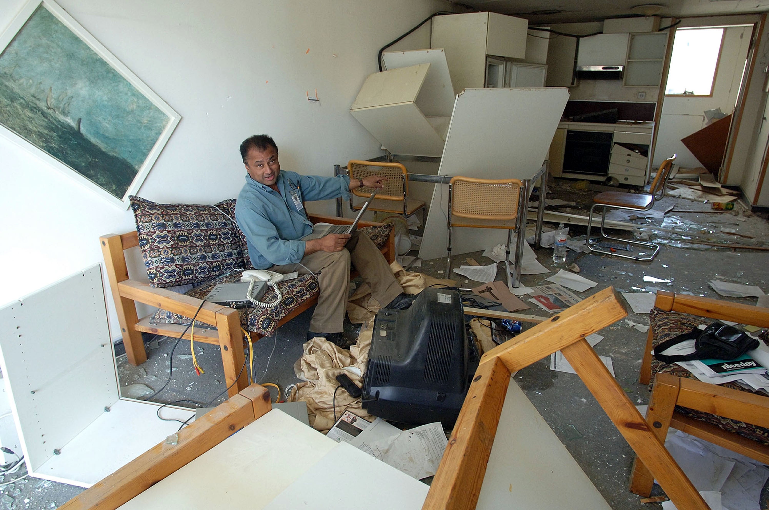 Close shave: Kim Sengupta in his room at the Hamra hotel in Baghdad in 2005