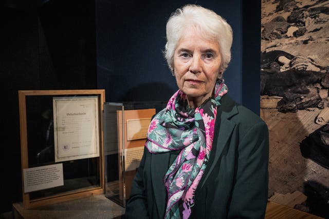 <p>Holocaust survivor, Eva Clarke, next to her birth certificate displayed at the Imperial War Museum. </p>