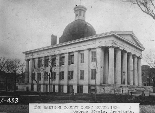 A historical black-and-white photo of the Madison County court house in Huntsville, Alabama.