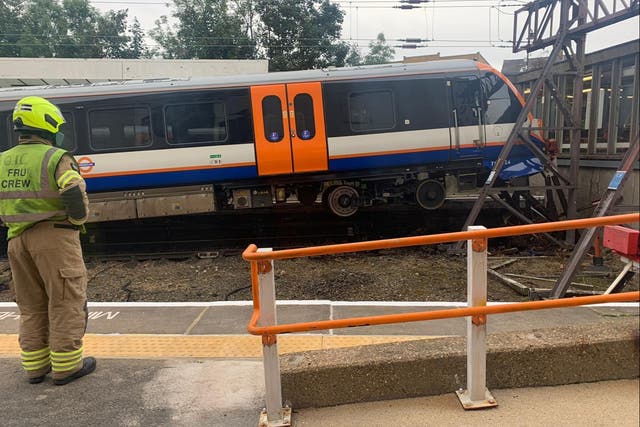 <p>Two people have been treated for minor injuries after an eight-carriage London Overground train crashed into buffers at Enfield Town station, causing it to derail. </p>