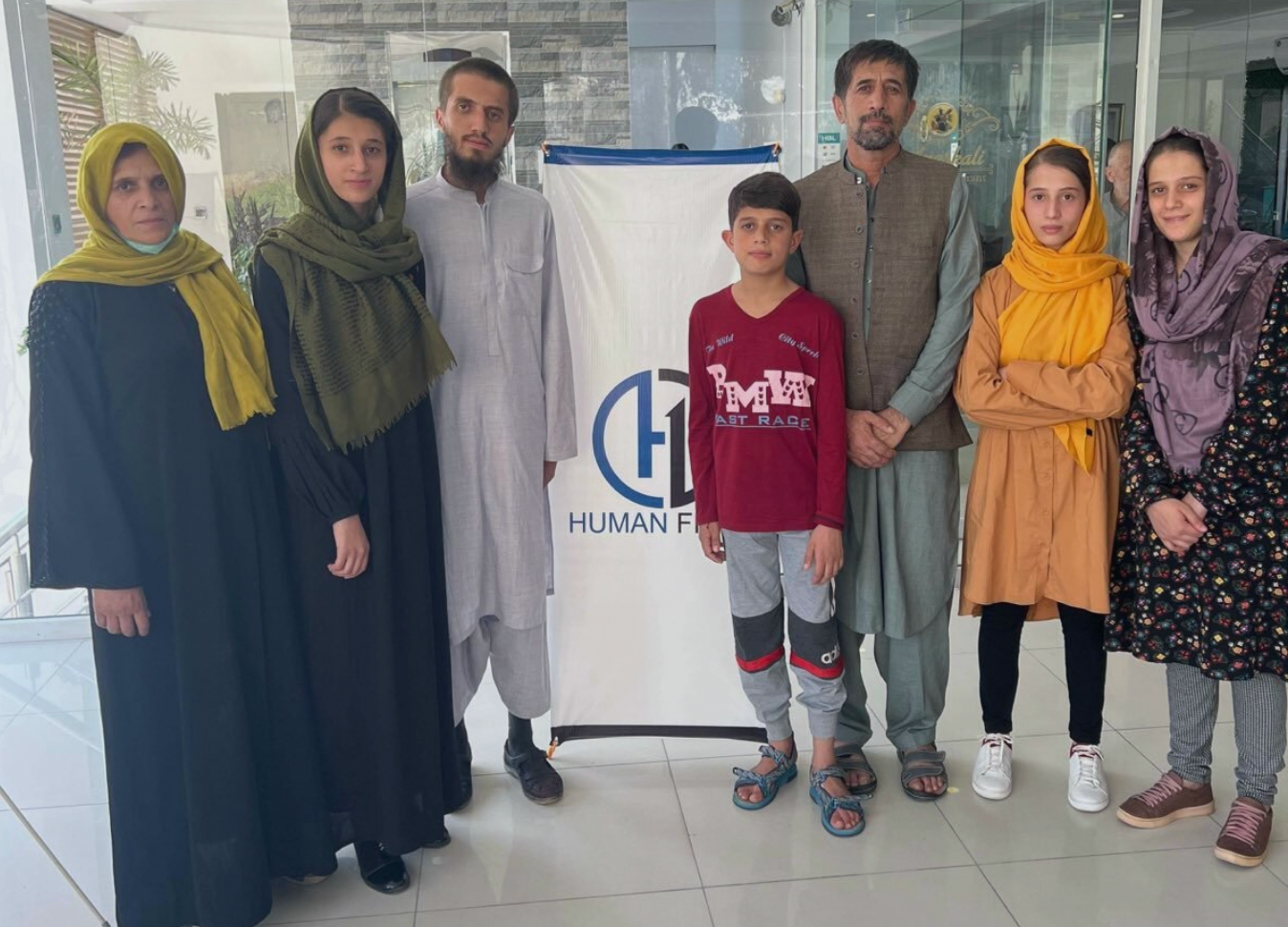 <p>Aman Khalili (third from right) and his family have reached safety</p>