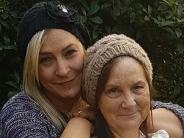 <p>Kelly Hartigan-Burns pictured (left) with her mother June, was found unresponsive in a Blackburn police cell in 2016 </p>