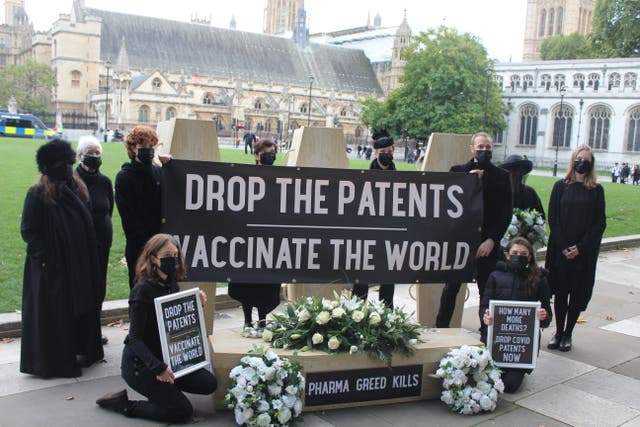 <p>Demonstrators campaign against the British government’s decision to block a vaccine patent waiver in Parliament Square, London, on 12 October, 2021. </p>